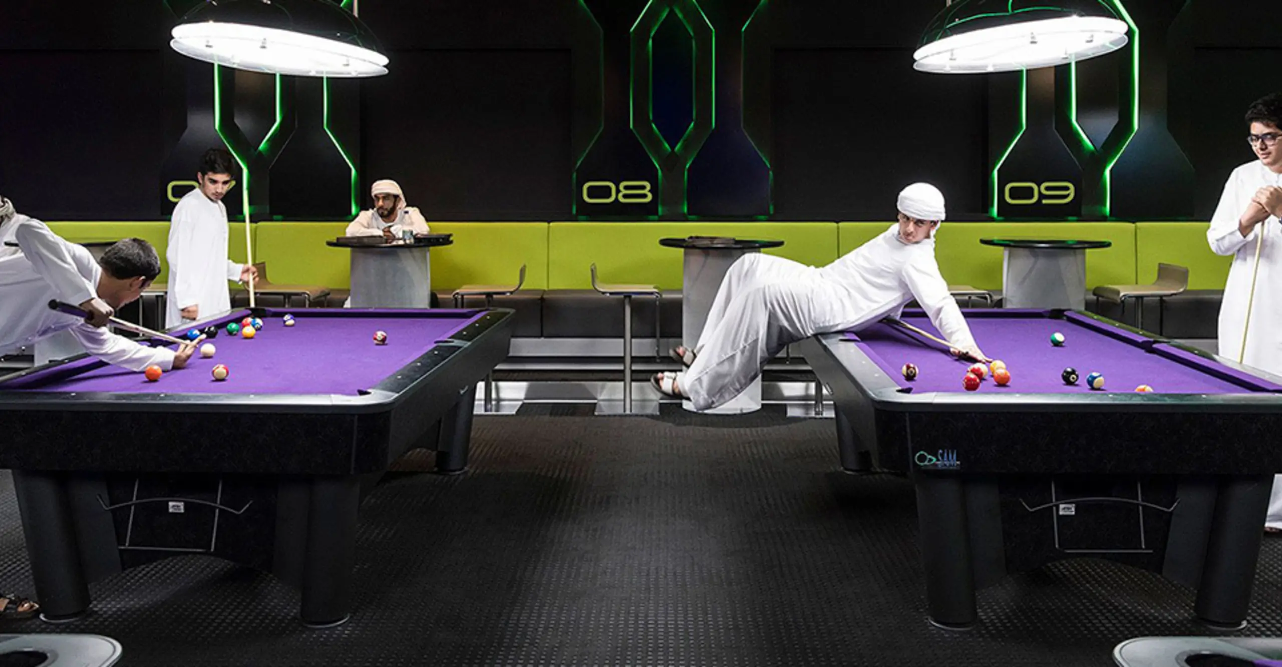 Hub Zero, Dubai, January 2017. Emirati boys playing a game of pool at Hub Zero, an im- mersive entertainment hub located at City Walk shopping mall. © Nick Hannes. Documen- tary Series Winner, Magnum and LensCulture Photography Awards 2017. 