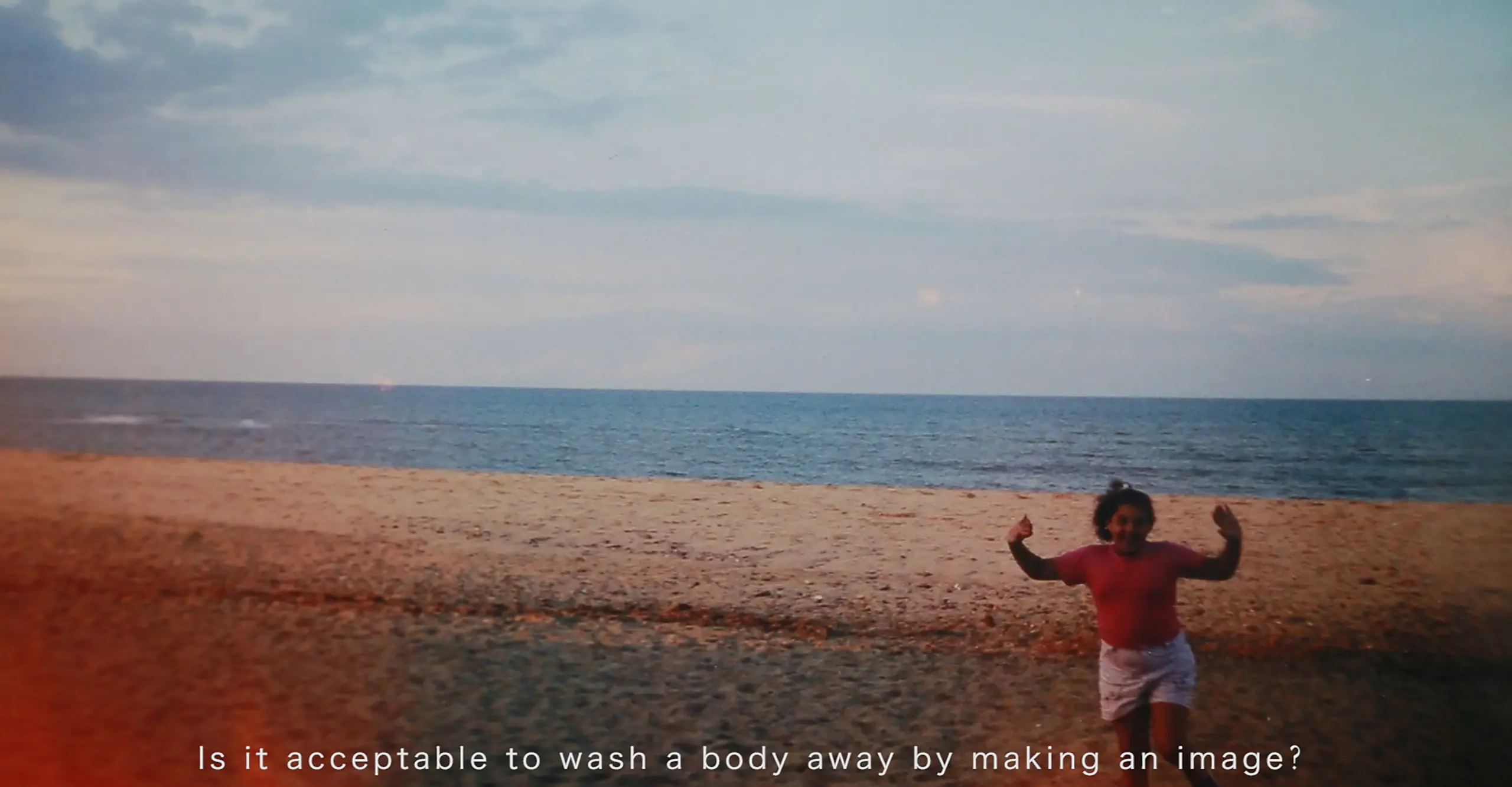 Landscape format image featuring a beach scene with a figure jumping in front and text in white font