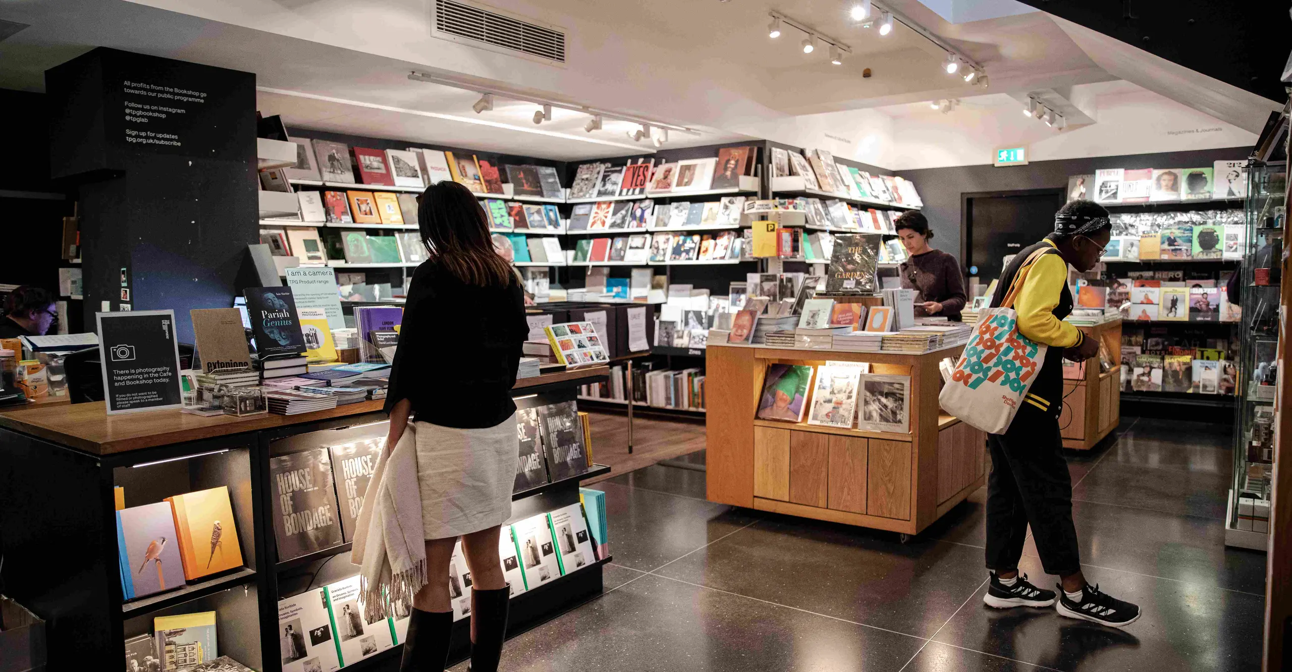 Colour photograph of people looking at books in a bookshop