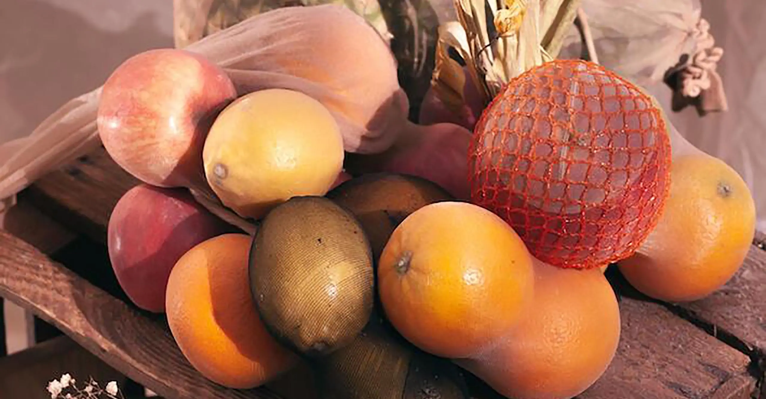 Fruit in the top of a wooden crate.