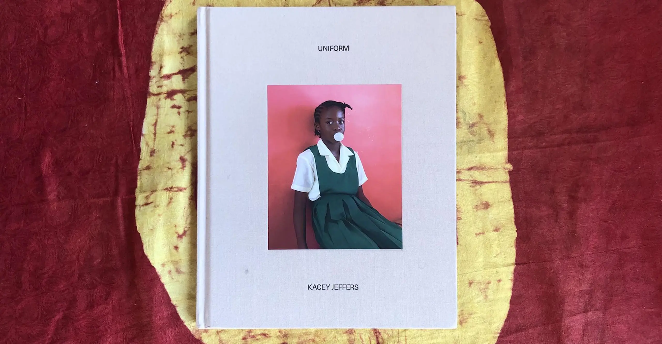 A book placed on a table with the front cover showing a photograph of a child in a school uniform