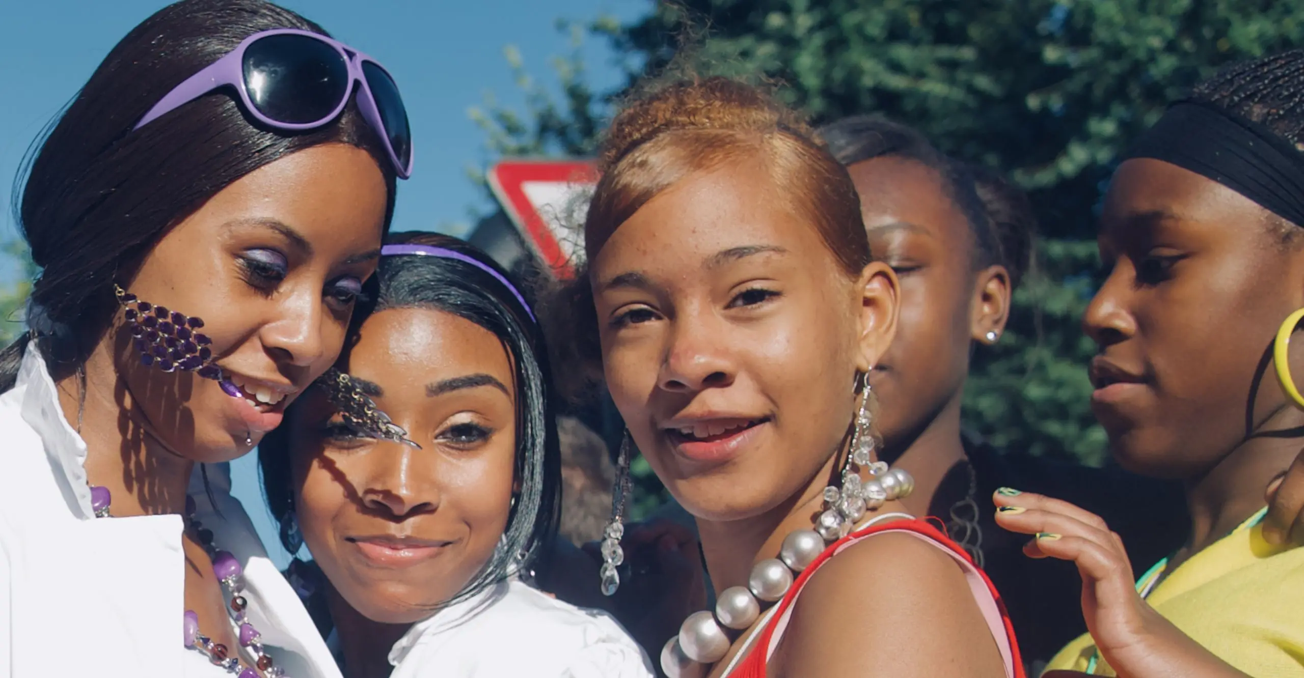 Group of young girls stood together, on a bright sunny day