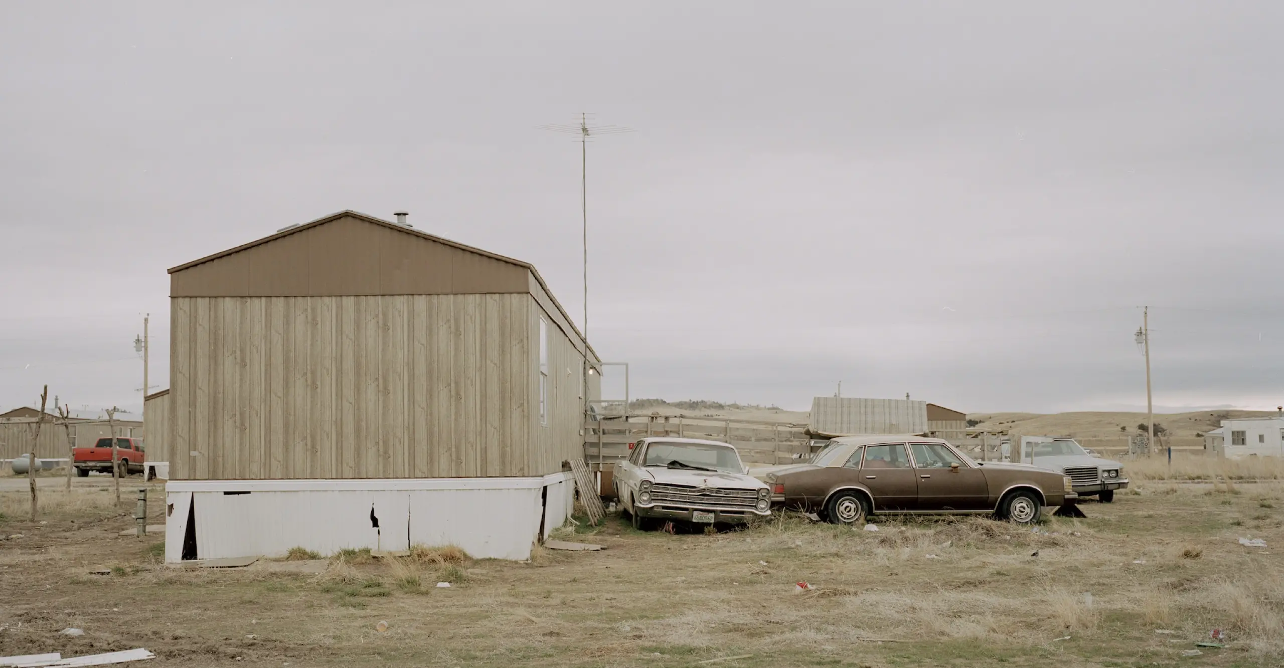 Landscape format outdoor shot of a rural land with a car