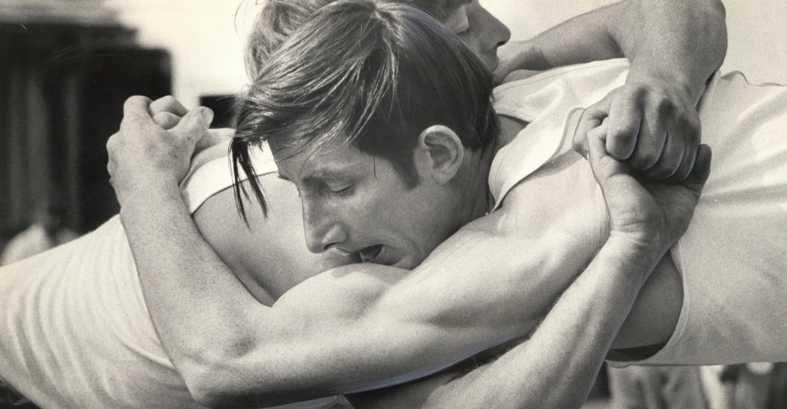 Photo of two white men wrestling in black and white