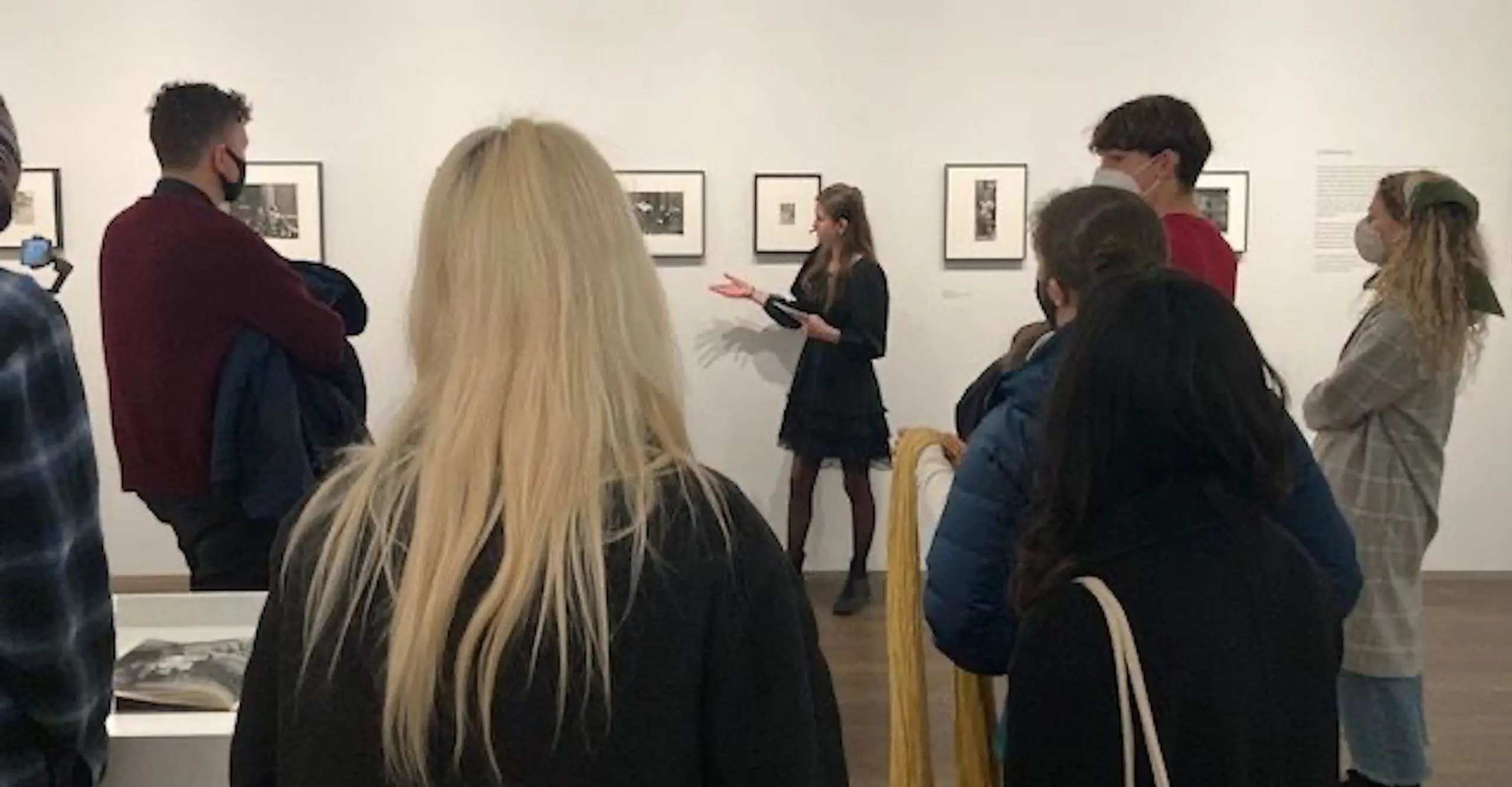 Photograph of a group of people at a tour led by a young person.