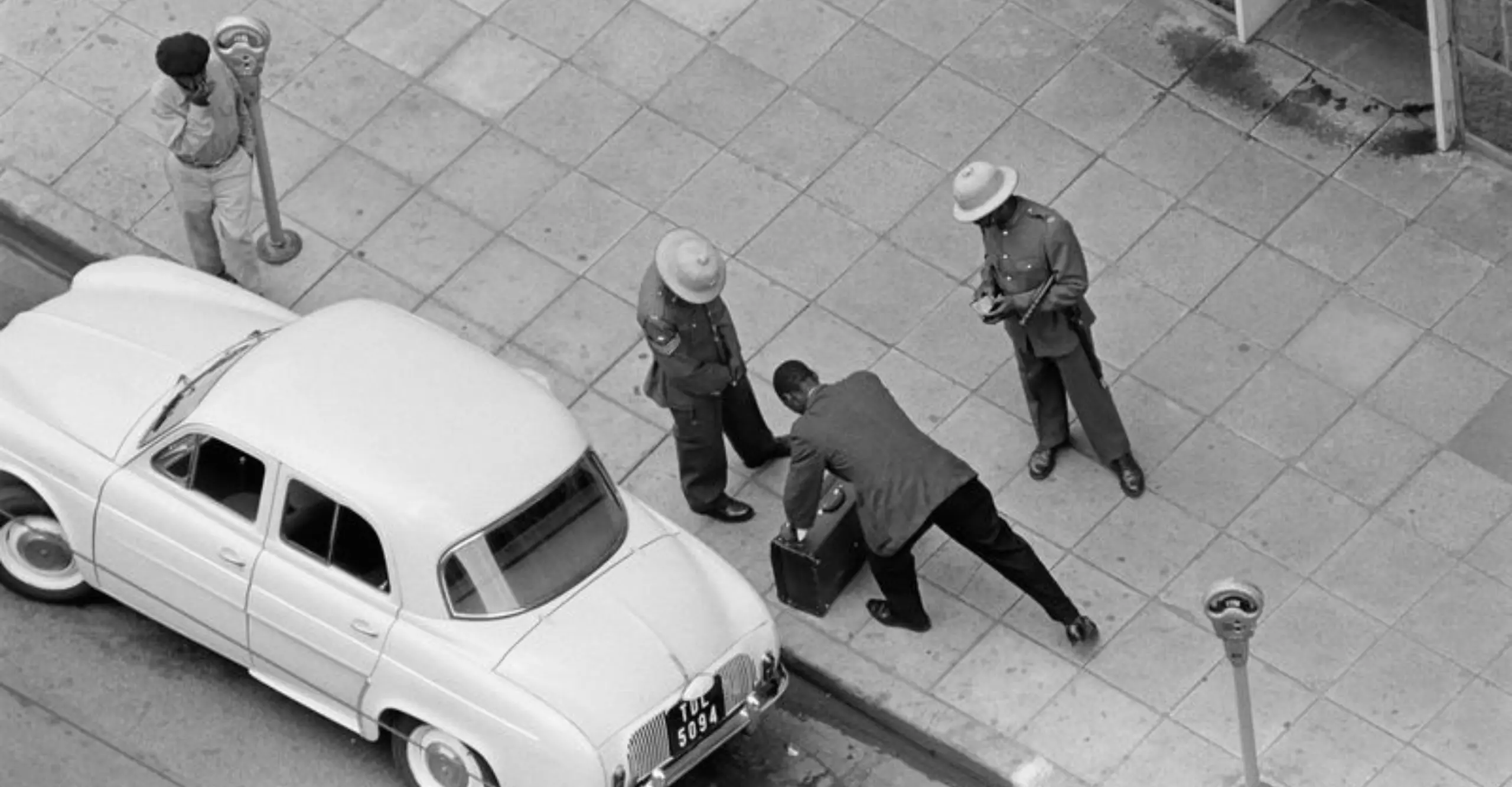 People moving suitcase into a car. 