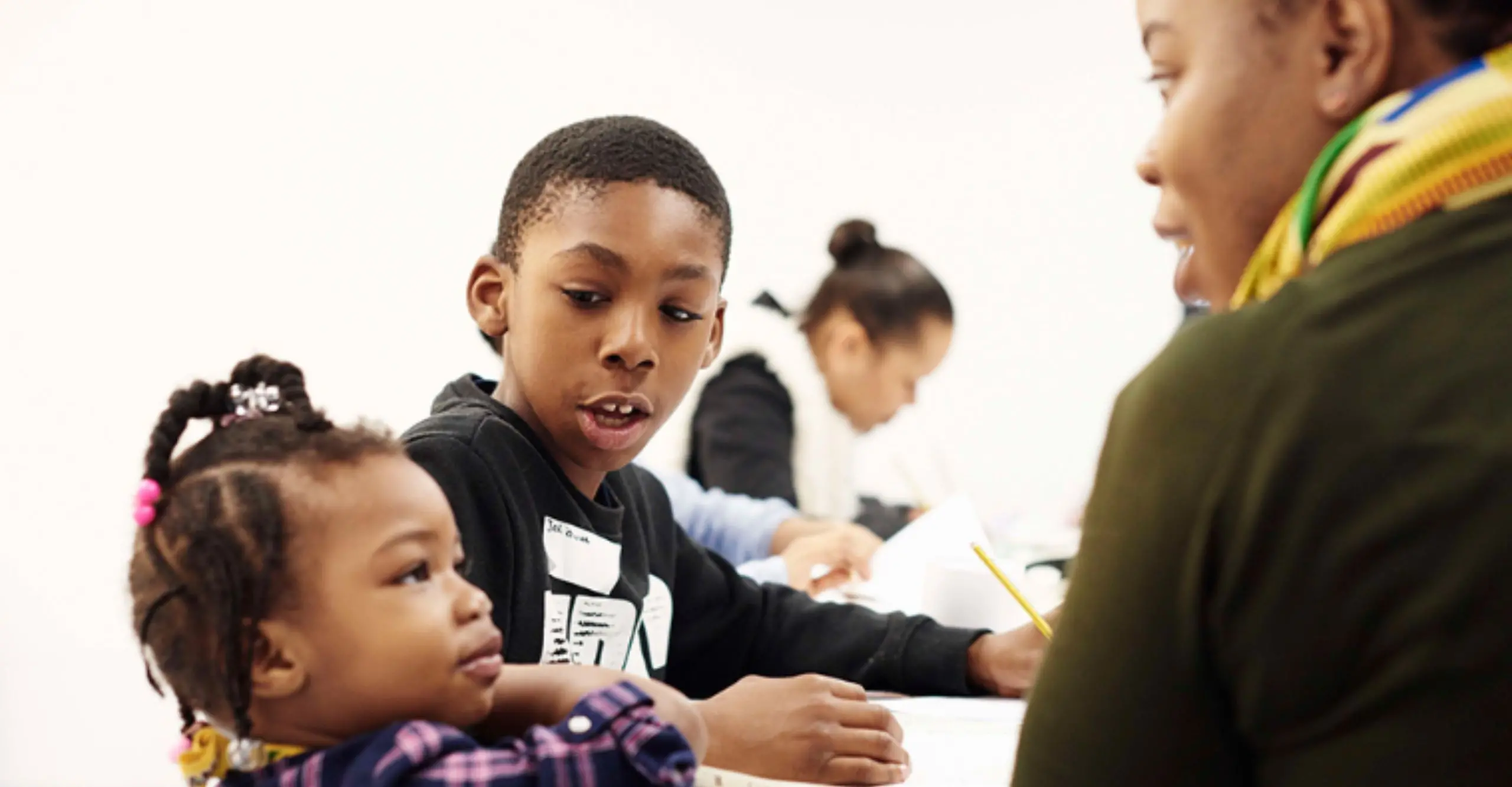 Image of two kids speaking to an adult.