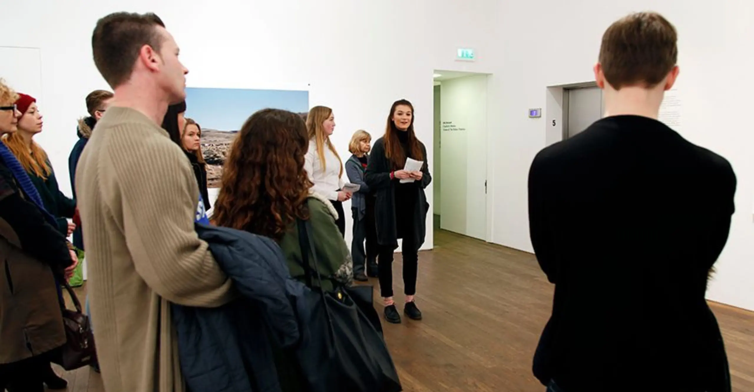 Photo of people listening to a tour.