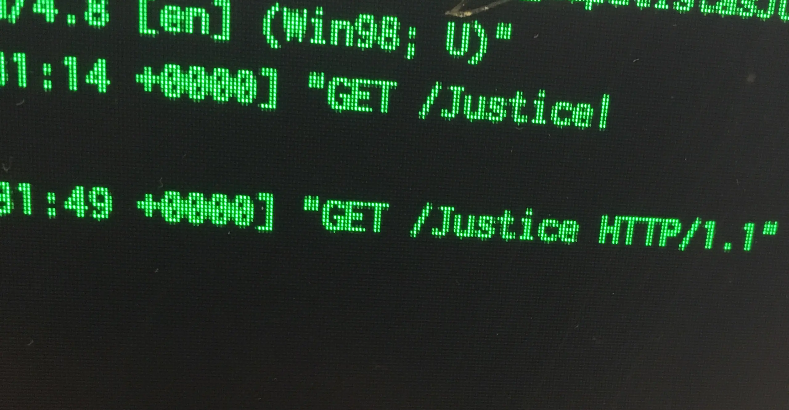 Close up of a screen with the "Get / Justice" text on it