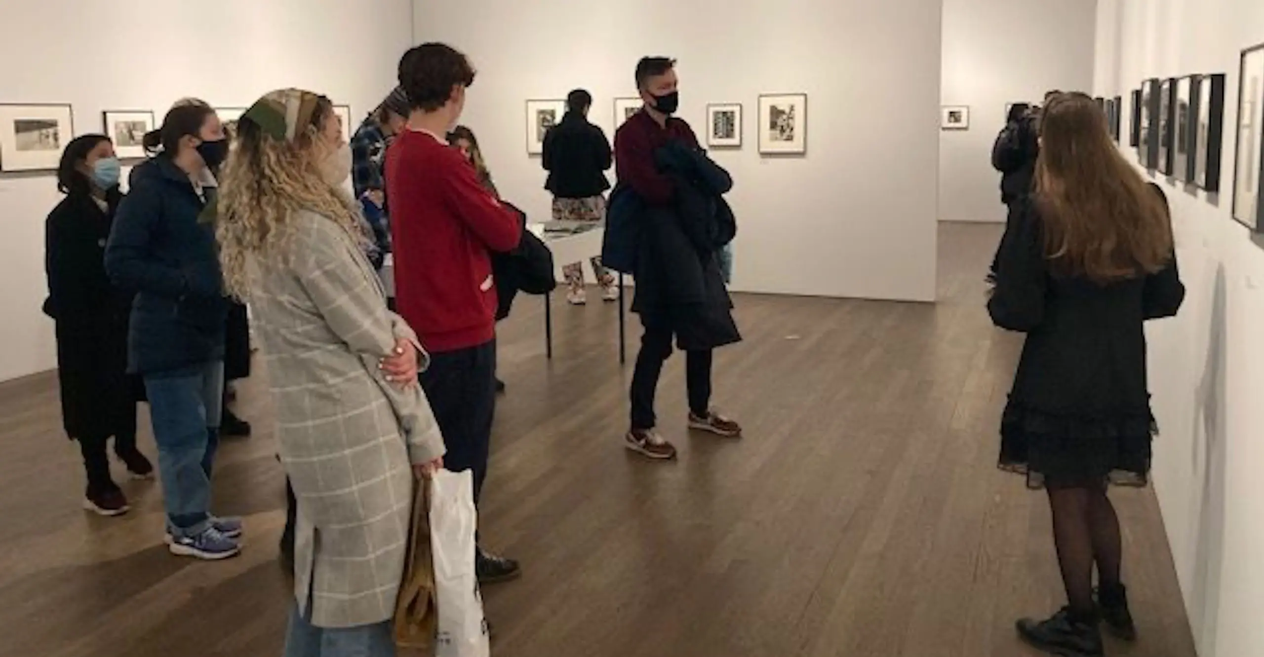 A young person giving a tour of an exhibition.